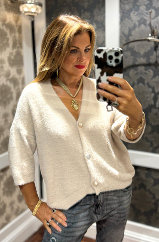 Super soft beige cardigan with a timeless design, perfect for layering and everyday comfort.