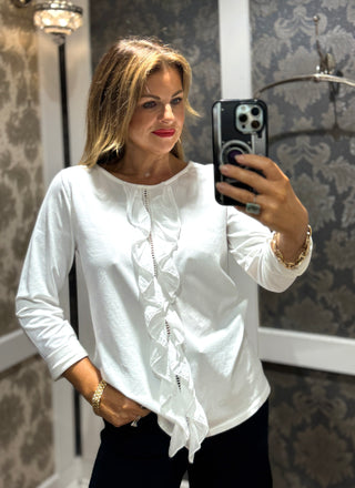This easy to wear top features crisp cuffs that frame alongside the delicate ruffle detailing along the front frill. Its clean white fabric and precise construction make it ideal for elevating both professional and refined casual looks. The perfect way to wear a simple white top with some extra flair. 
