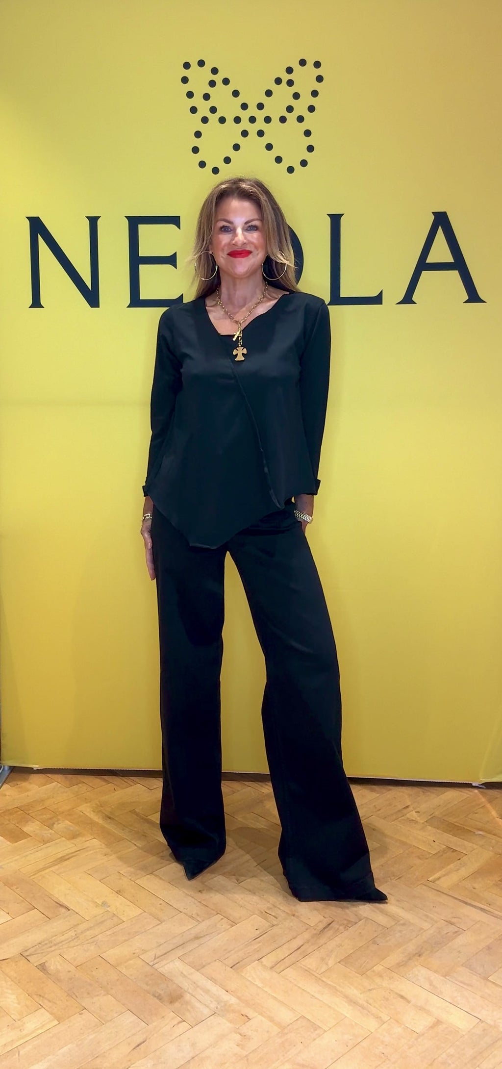This black long sleeve top features stylish 3/4 length cuffed sleeves for a polished touch. The asymmetrical neckline and hem create a modern silhouette, while the stitch detail across the front adds unique character. Perfect for those who appreciate subtle, distinctive design that sets you apart effortlessly.