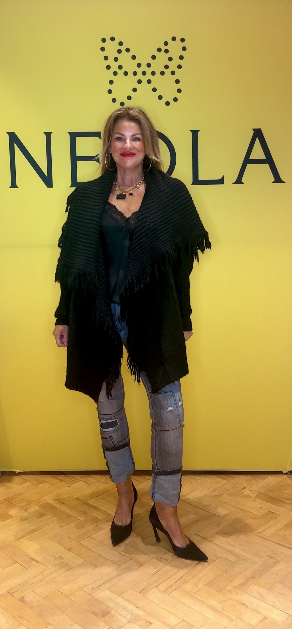 Blend of style and comfort with this knitted black poncho. Featuring a chunky knit texture and a chic fold-over collar, it offers cozy warmth while making a bold fashion statement. Elevate your wardrobe instantly with this versatile piece that effortlessly transforms any outfit into a sophisticated look.