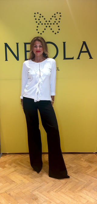 This easy to wear top features crisp cuffs that frame alongside the delicate ruffle detailing along the front frill. Its clean white fabric and precise construction make it ideal for elevating both professional and refined casual looks. The perfect way to wear a simple white top with some extra flair. 